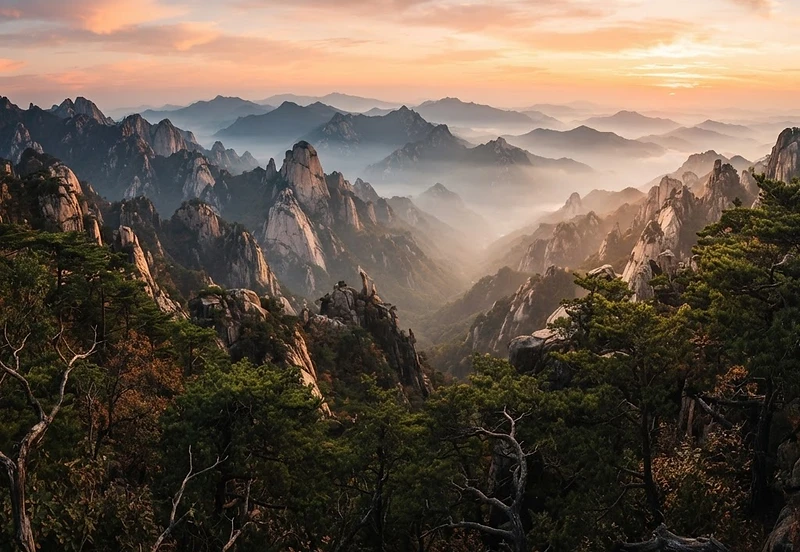 Dramatic panoramic Korean mountain landscape at golden hour, layered granite peaks and ridges