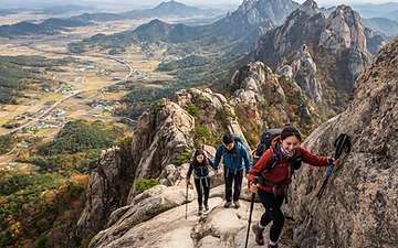 Hikers on the exposed granite ridge of Wolchulsan