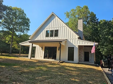 White Barndominium with Stone Chimney