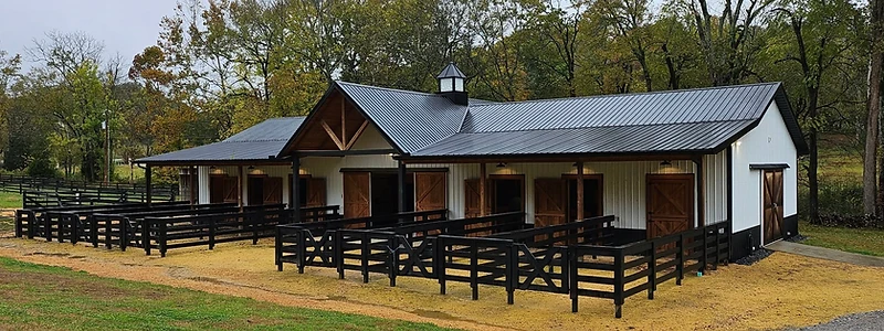 Custom horse barn with turnout paddocks in Middle Tennessee