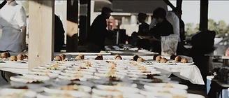 Plates lined up at the outdoor kitchen pass