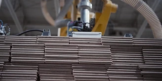 A robotic gripper placing hardwood boards