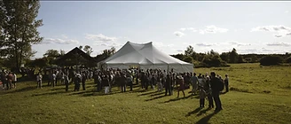 Guests gathering in the field before the feast