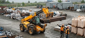 Telehandler lifting palletized steel pipe in a private industrial-supply yard near Belledune.