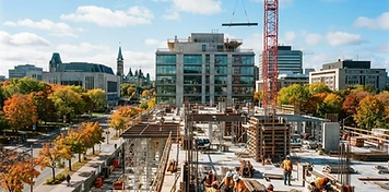 Construction crews building a modern office project in bright downtown Ottawa, Ontario