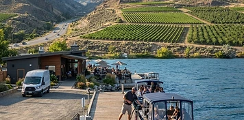 Desert-lake vineyards and border-town businesses in Osoyoos, BC