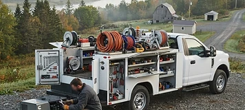 Mobile service technician working at a rural commercial job site near Perth-Andover.