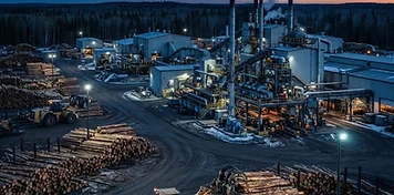 Sawmill and forest-products yard in northern Saskatchewan at dusk