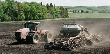 Modern tractor and air seeder working Swan Valley farmland in bright daylight