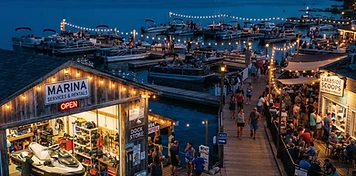 Marina service shop, pontoon boats and boardwalk businesses at Sylvan Lake at dusk