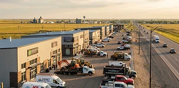 New commercial buildings and trade-service fleets along the Highway 11 growth corridor at Warman, Saskatchewan