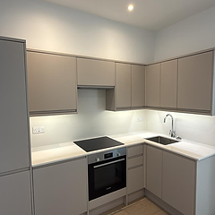 Fitted taupe kitchen with Bosch oven and under-cabinet lighting