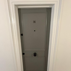 Grey painted four-panel front door with chrome letter plate