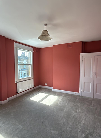Terracotta feature wall in a redecorated bedroom
