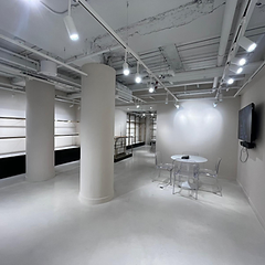Retail showroom with soft greige walls, painted columns and polished floor