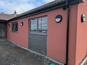 Single-storey EWI with reddish render and brick panel, Mayo
