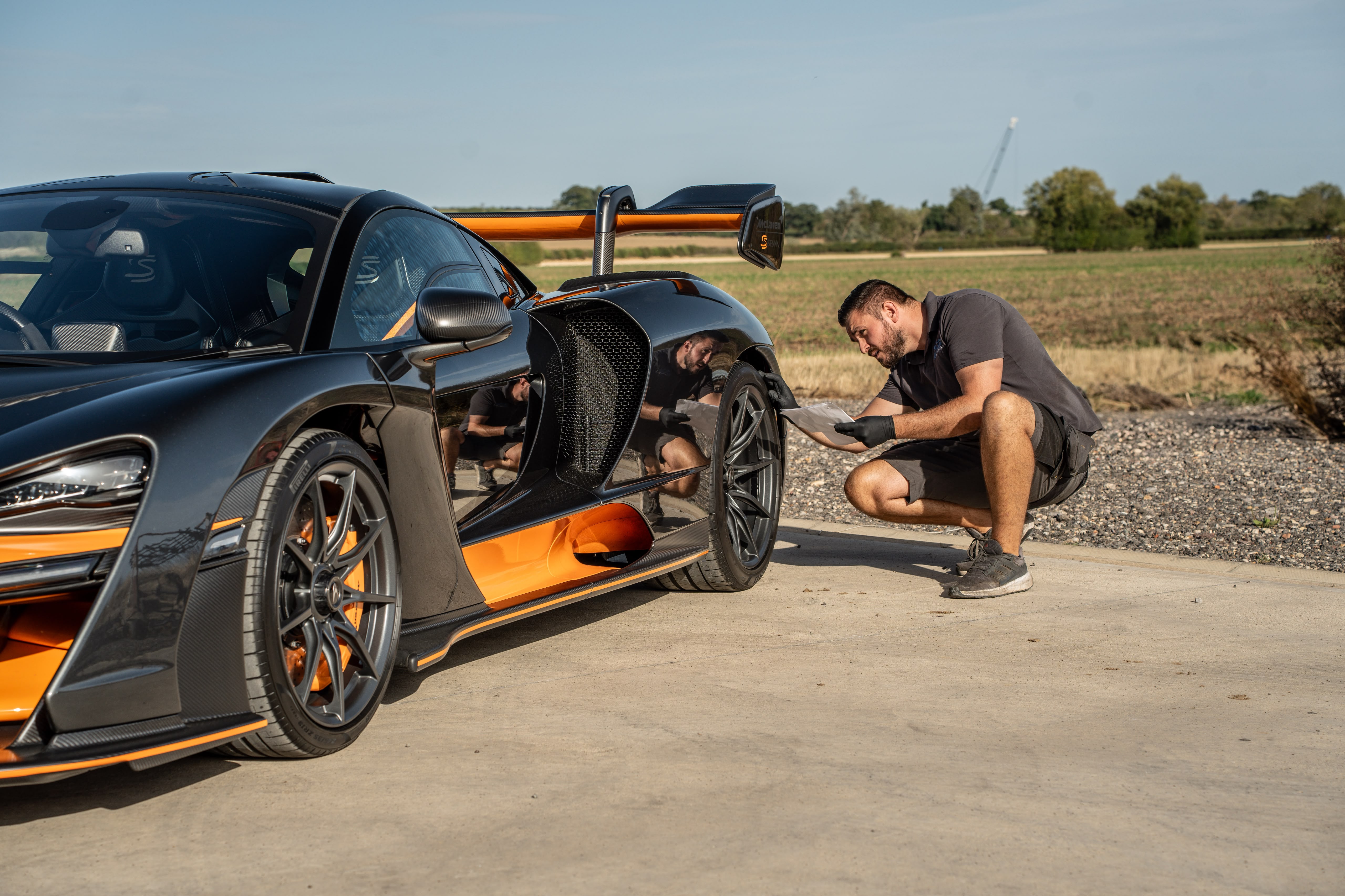 Technician inspecting a McLaren Senna