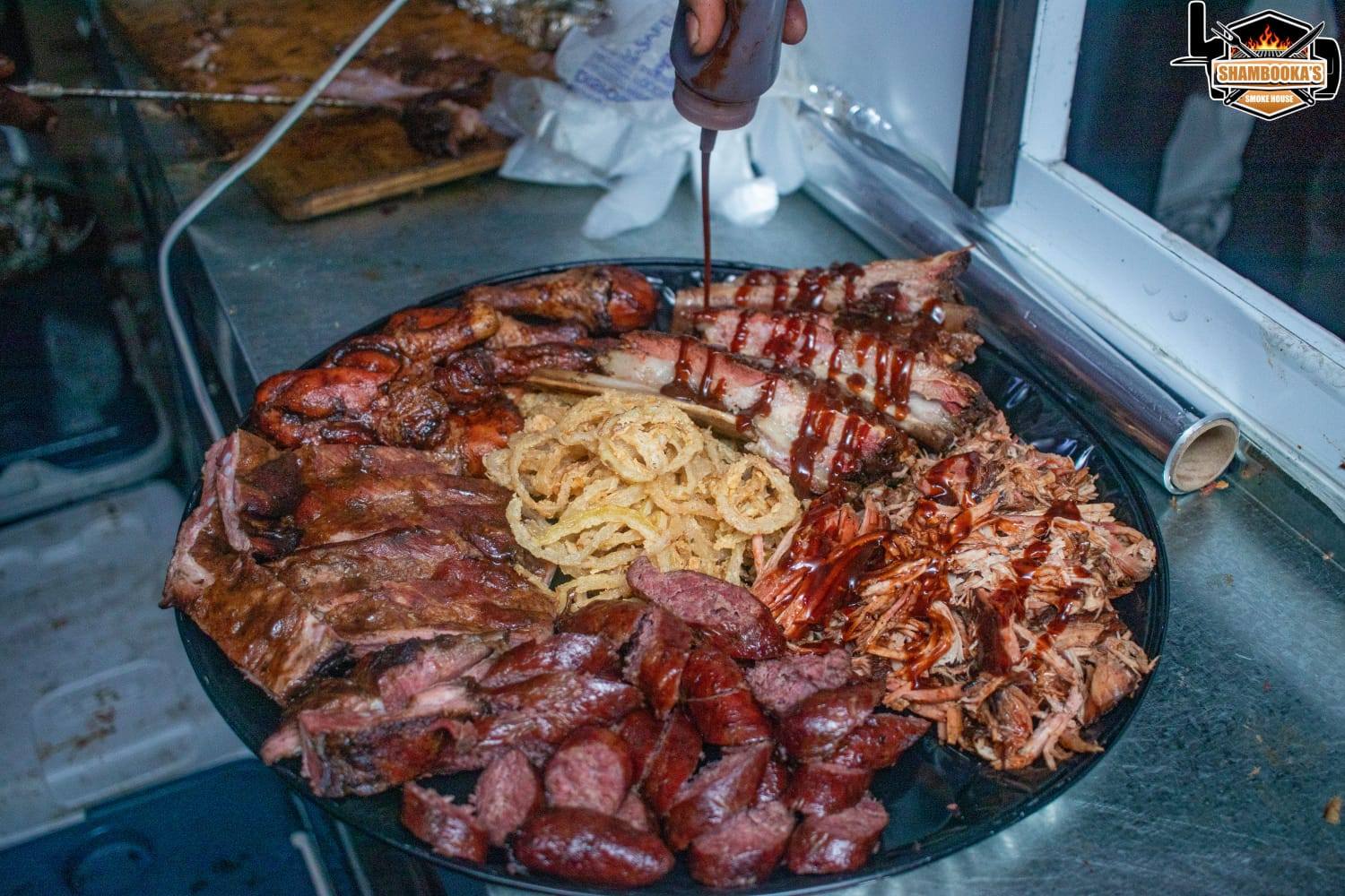 Shambooka's Smoke House platter with ribs, pulled pork, sausage, chicken and onion straws