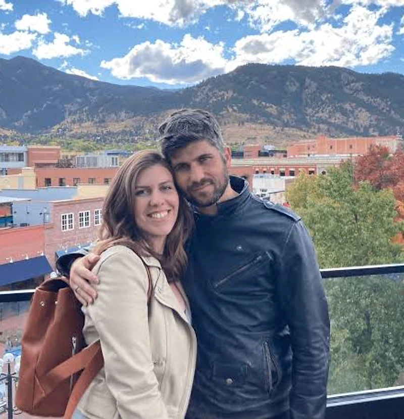 Ben and Shira after moving to Boulder, Colorado, with the Flatirons behind them.