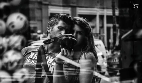 Ben and Shira taking a black-and-white self-portrait with Ben's camera during their journey.