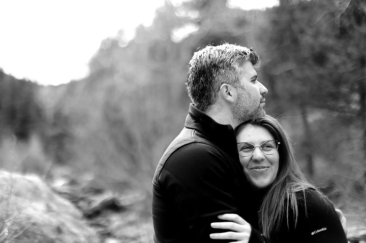 Ben and Shira embracing in a black-and-white portrait.