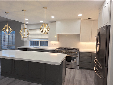 Modern charcoal and white kitchen with waterfall island and gold accents