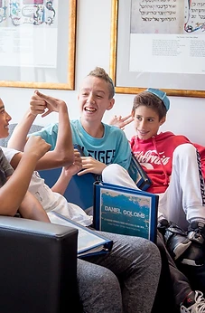 Boys laughing together on the couch during a BMC session
