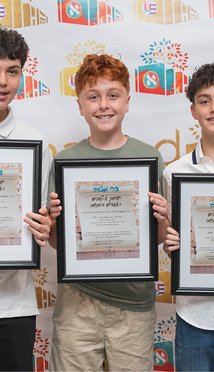 Three BMC graduates proudly holding their Bar Mitzvah certificates