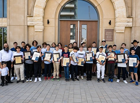 The BMC graduating class with Rabbi Benny holding their certificates outside the Chabad Israeli Centre