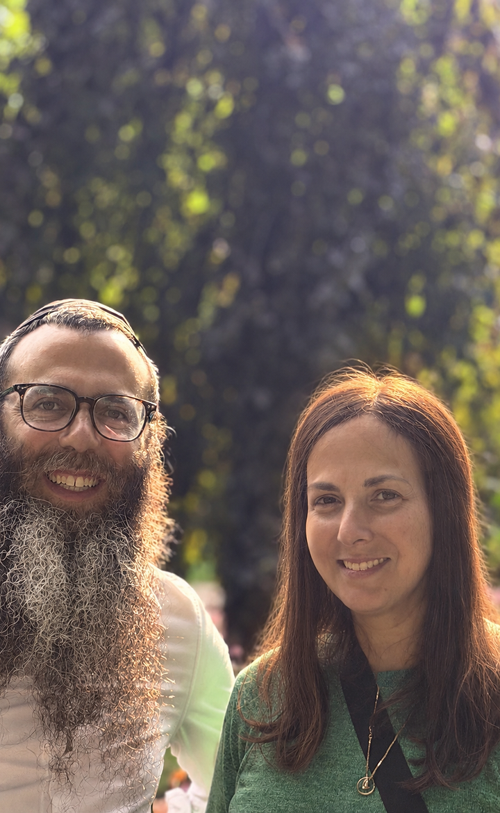 Rabbi Benny and Bosmat Kamchaji smiling together outdoors