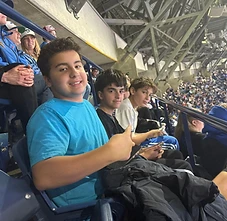 BMC boys enjoying a sports game together from the stands