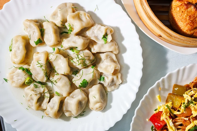 Boiled dumplings garnished with fresh dill