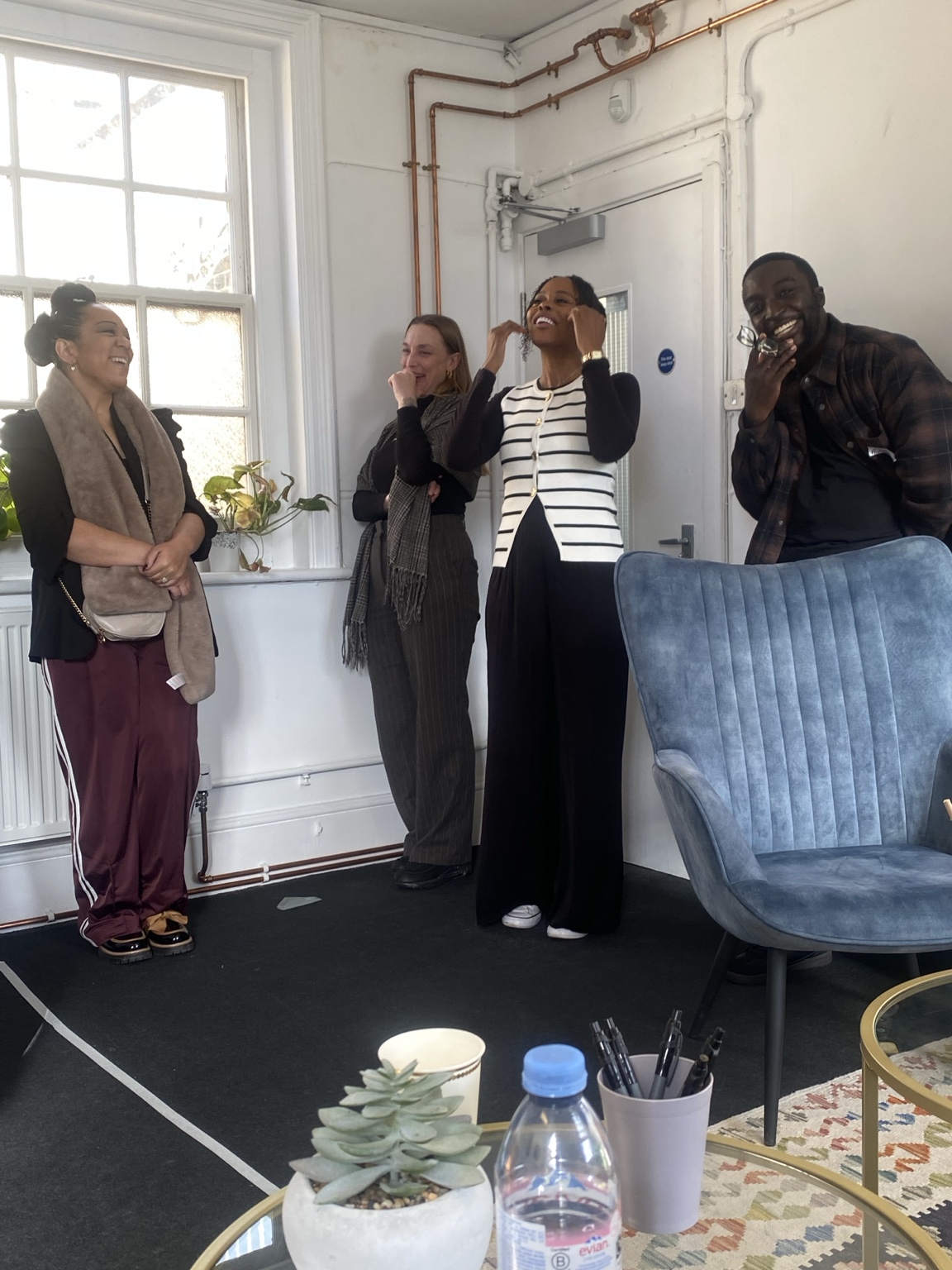Participants sharing a light moment at a House Of Order workshop