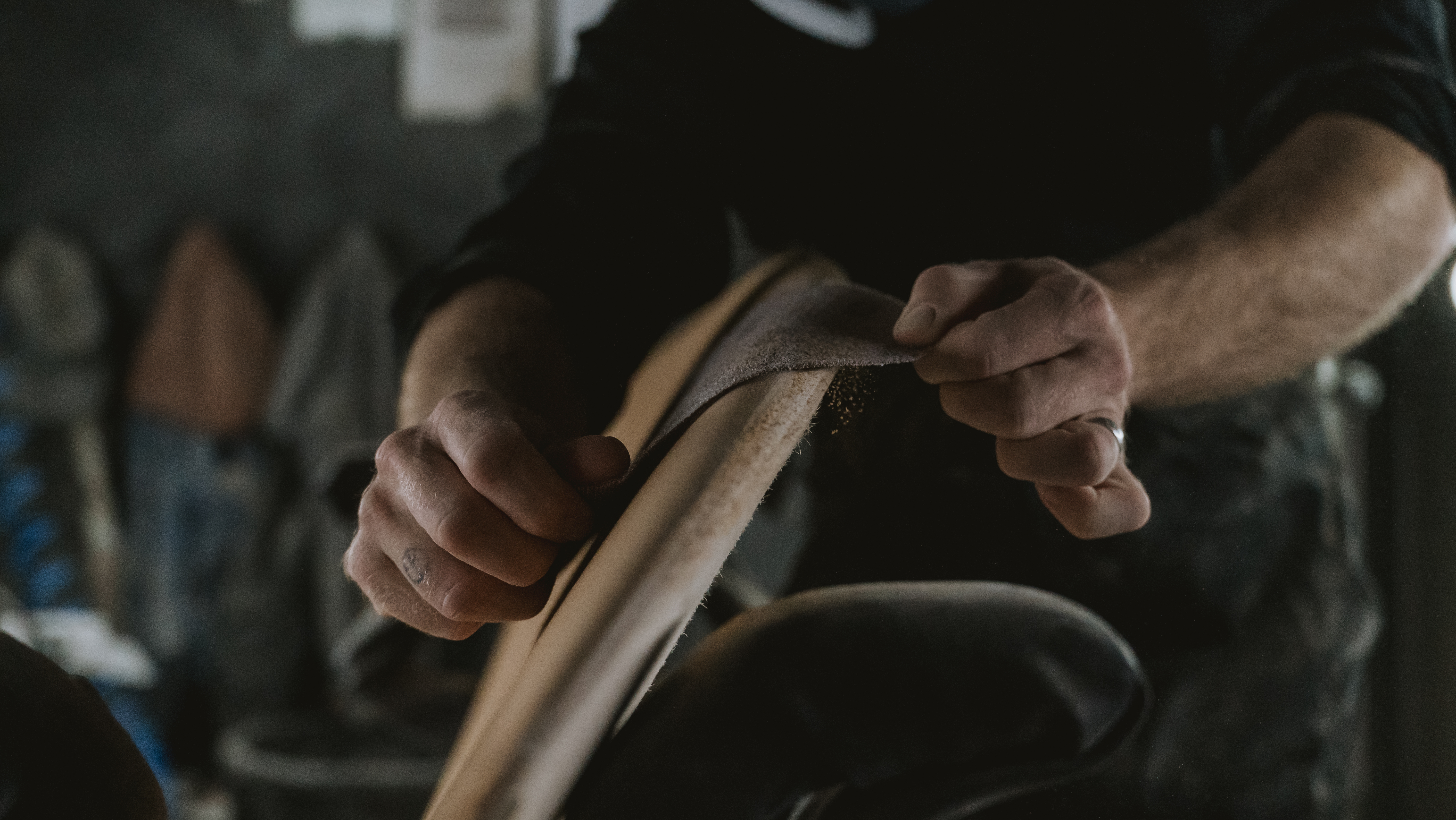 Shaper sanding a wooden rail
