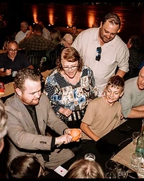 Guests react to close-up magic at a Sydney event, photo 8
