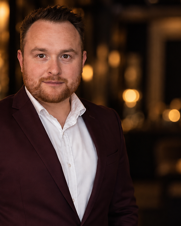 Benny The Magician, Sydney wedding MC and magician — portrait in red jacket