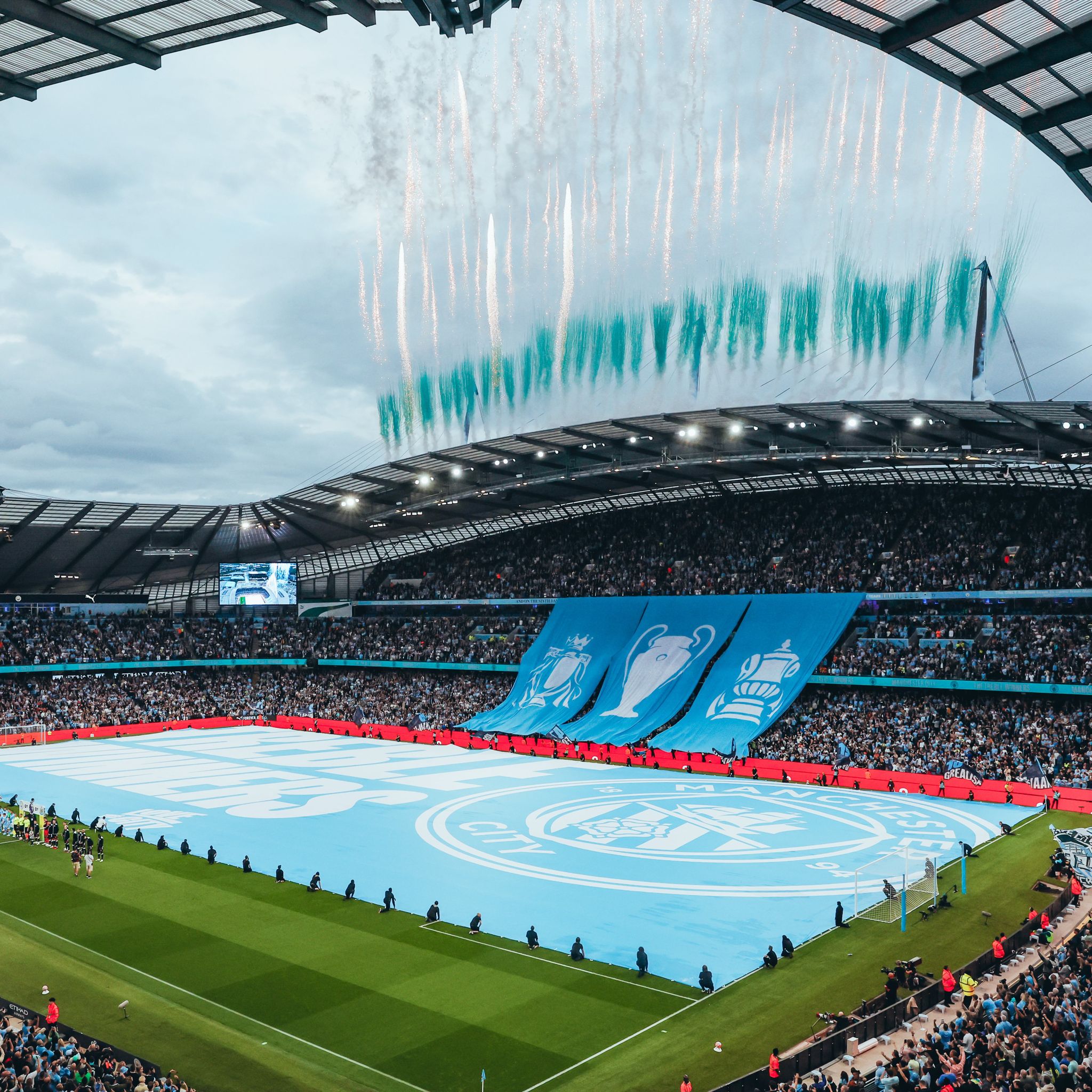 Massive pitch flag covering a football pitch in a packed stadium