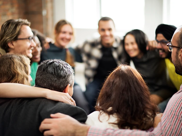 Volunteers embracing in a circle of community
