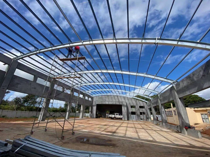 Interior steel framing with scaffolding and workers