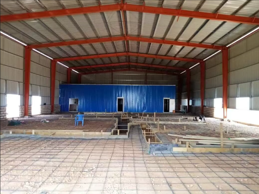 Interior framing with red I-beams and blue partition wall