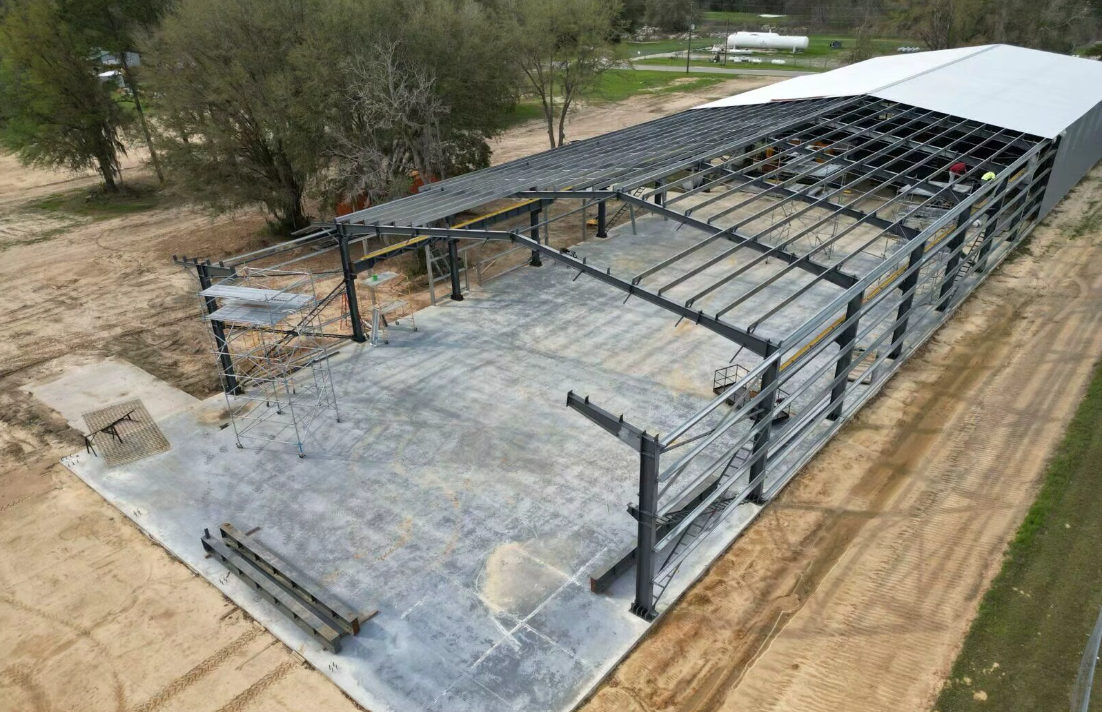 Aerial view of steel frame with roof sheeting in progress