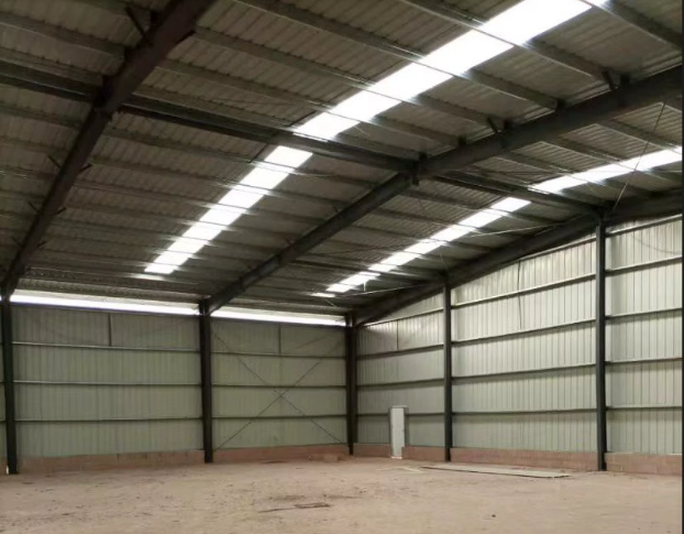 Steel-frame warehouse interior under construction with natural light