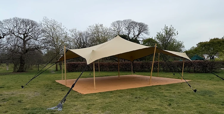 Stretch tent set up on a grass field