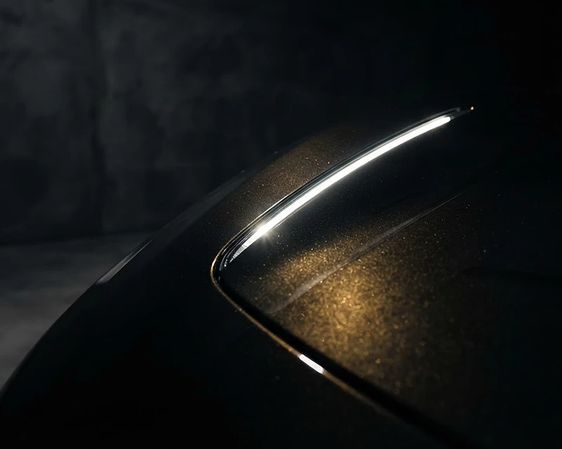 Macro reflection across a polished luxury hood