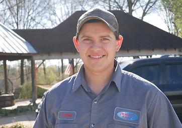Tyler, a Heavenly Aire HVAC technician, smiling in his company uniform shirt in Seneca, SC.