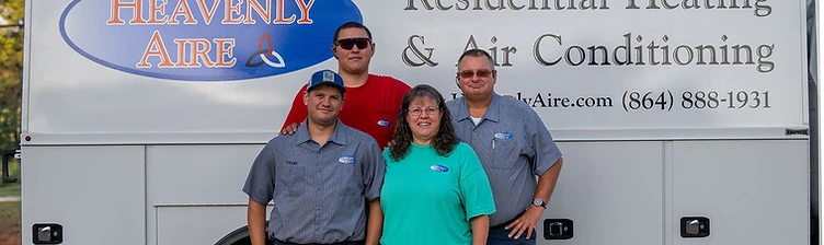 Group photo of Heavenly Aire technicians and staff standing in front of a company service van in Seneca, SC.