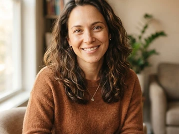 A smiling adult in a warm, welcoming setting