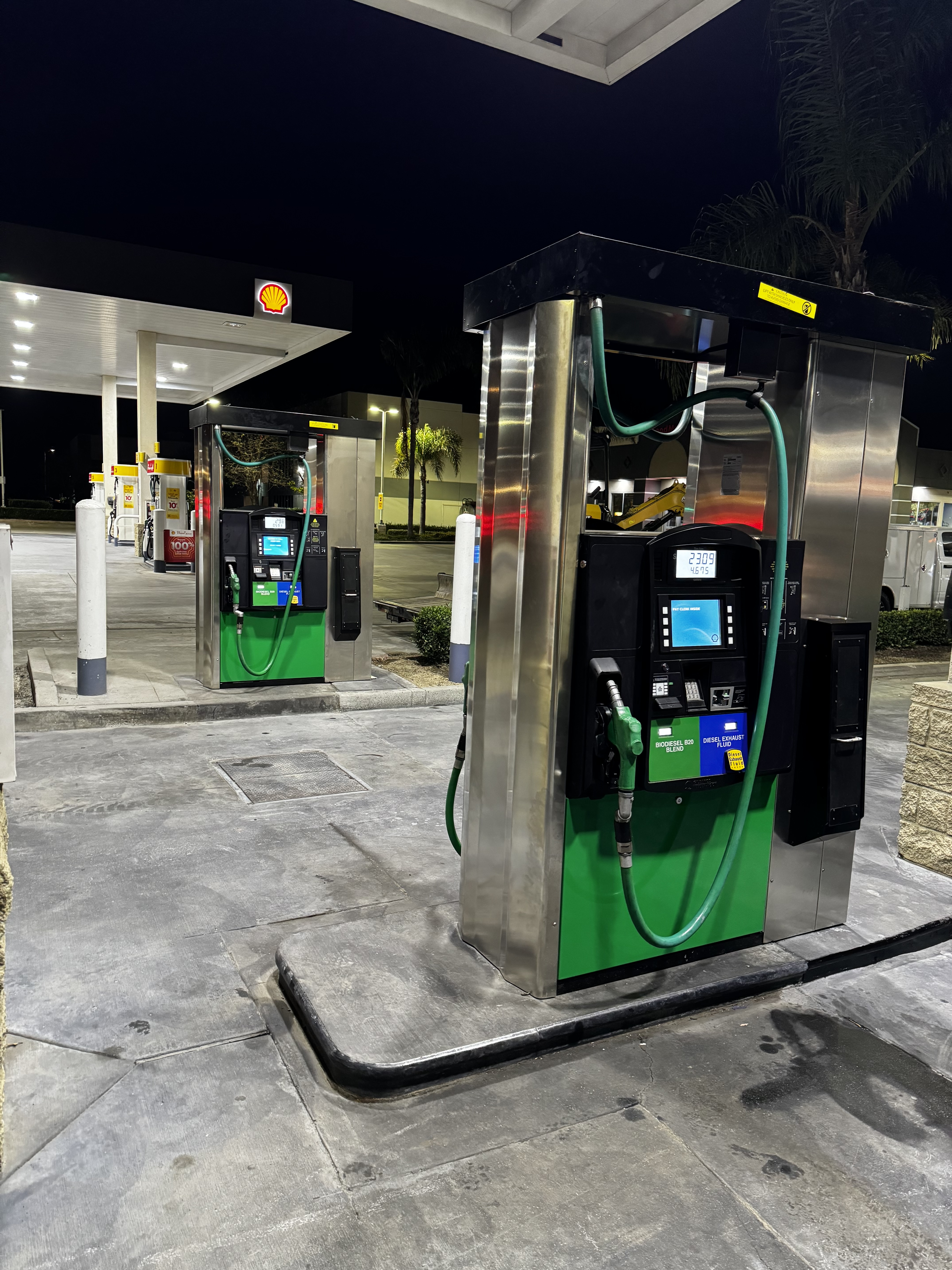 Row of commercial fuel dispenser nozzles at a gas station