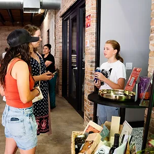 Shoppers chatting around the community giveaway and raffle table