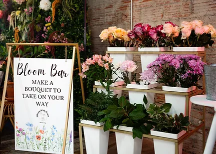 Tiered roses and spring blooms on display at the Bloom Bar flower booth